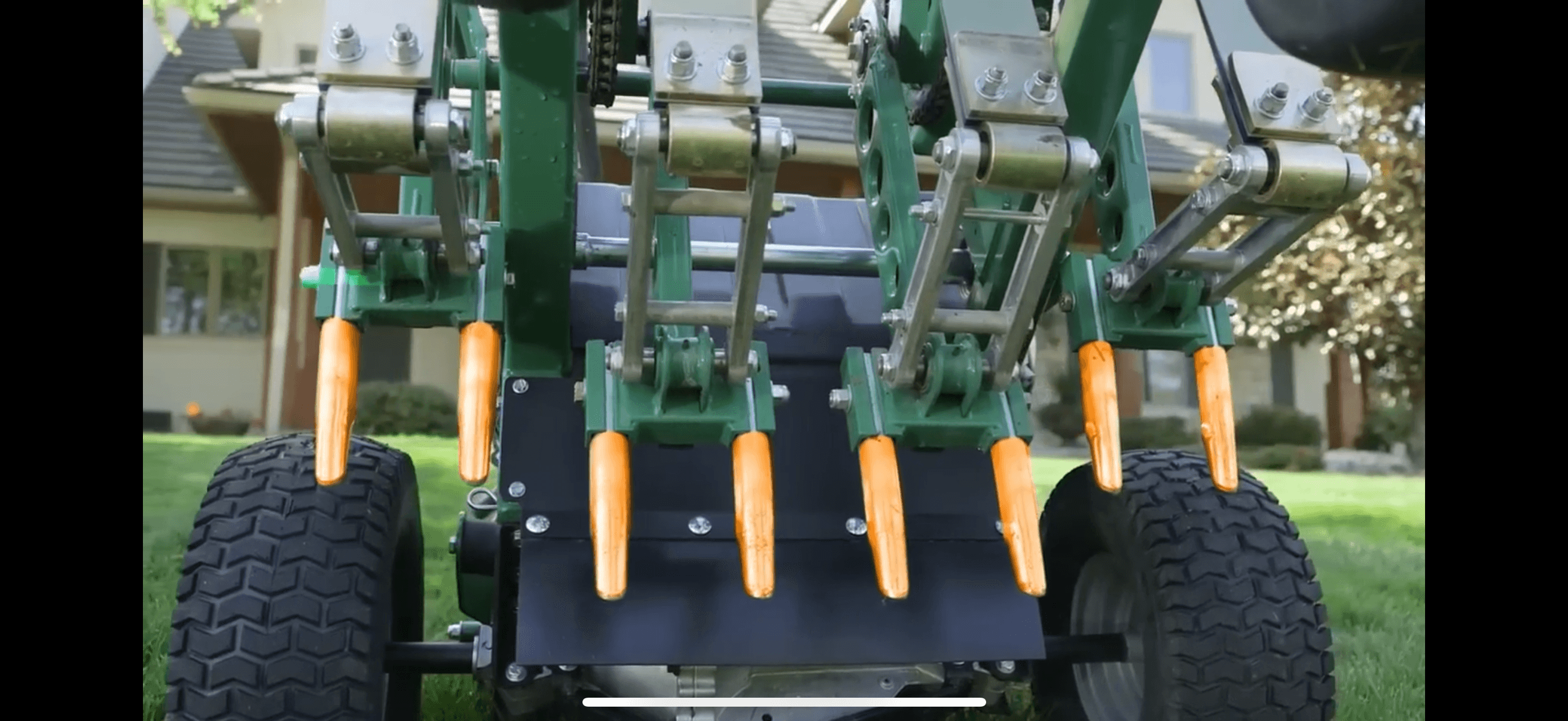 Close-up of core aerator tines that pull plugs from compacted turf