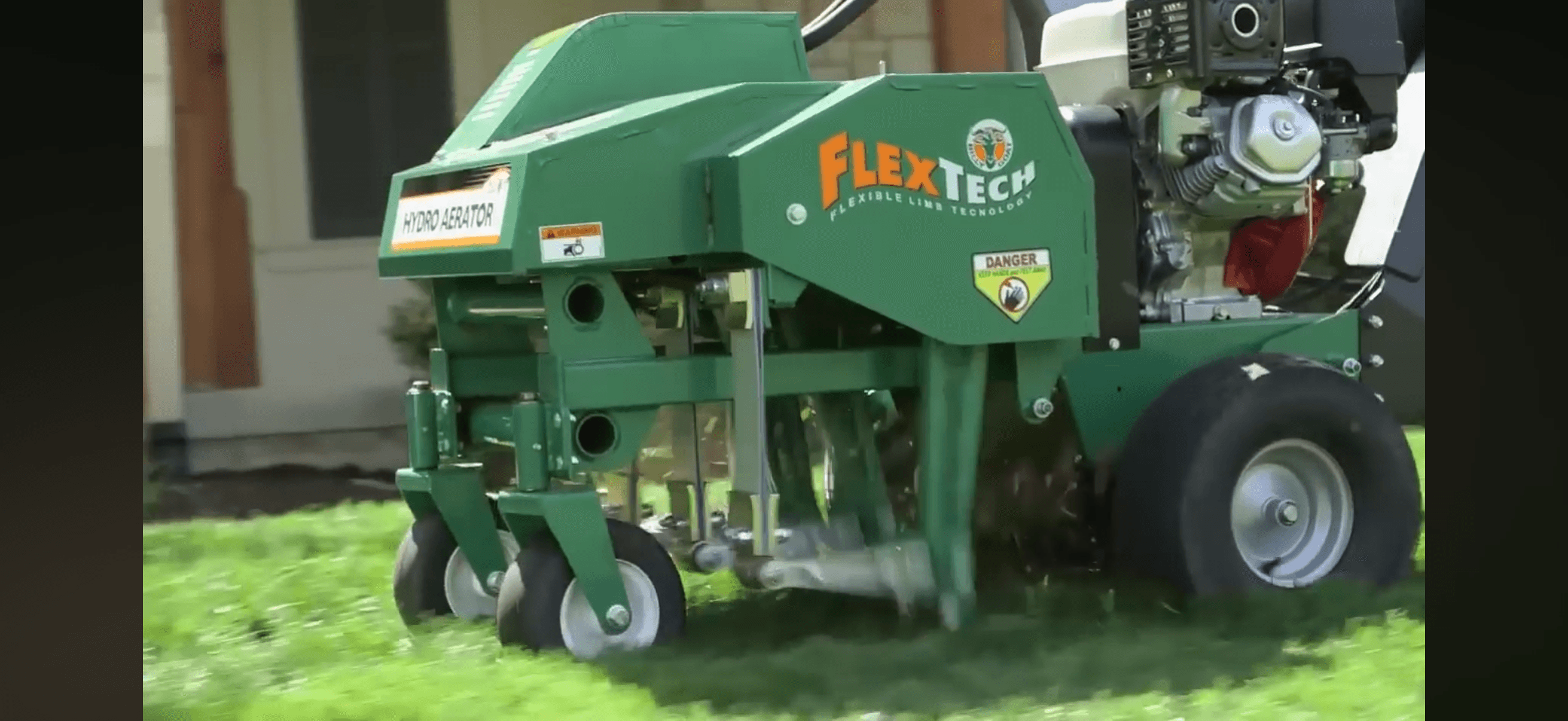 Core aerator machine pulling soil plugs across a residential lawn